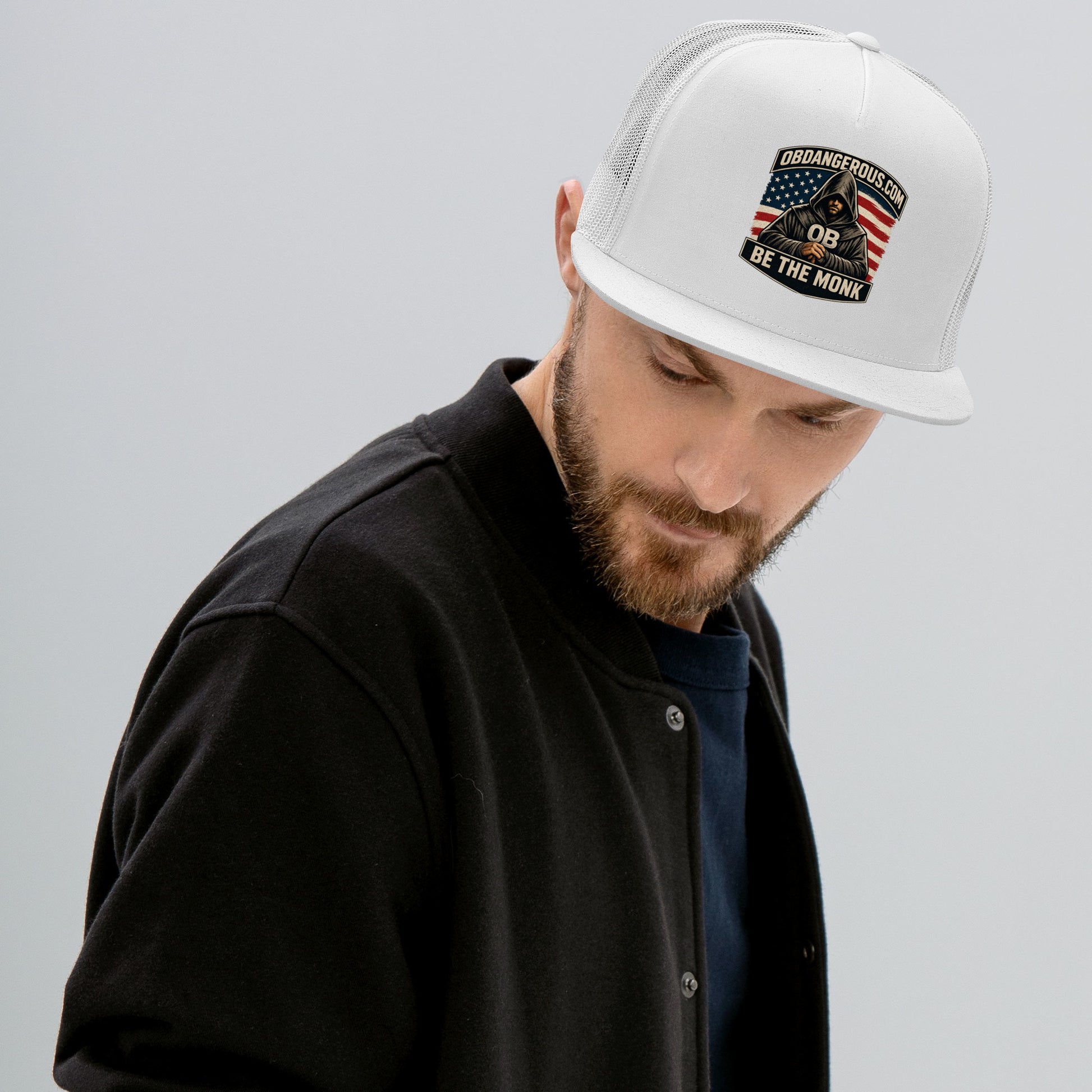 White embroidered Be The Monk trucker cap by OB DANGEROUS featuring a 5-panel design, suitable for gym and streetwear styles.