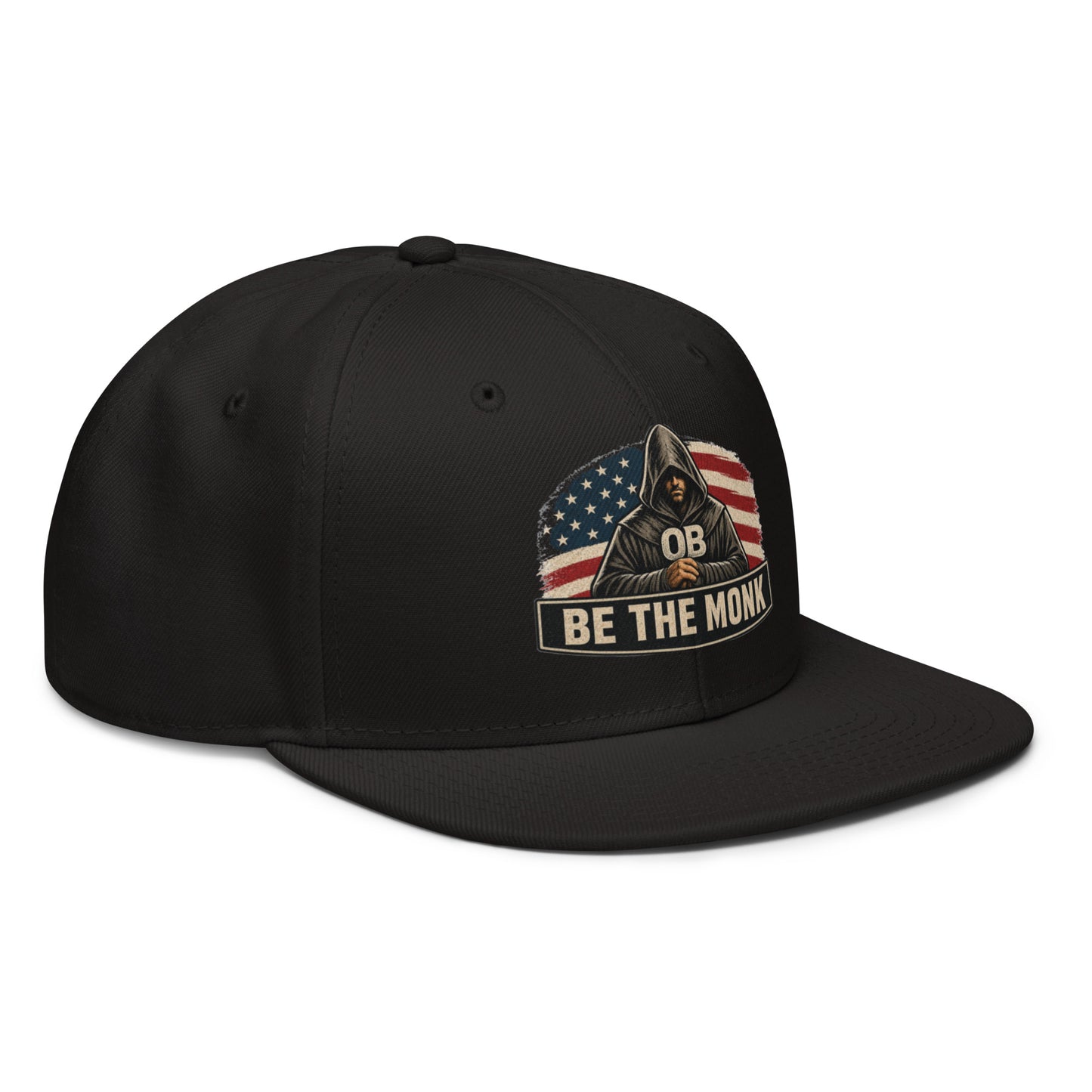 Black embroidered snapback hat by OB DANGEROUS with "Be The Monk" design, featuring a front logo and structured brim.