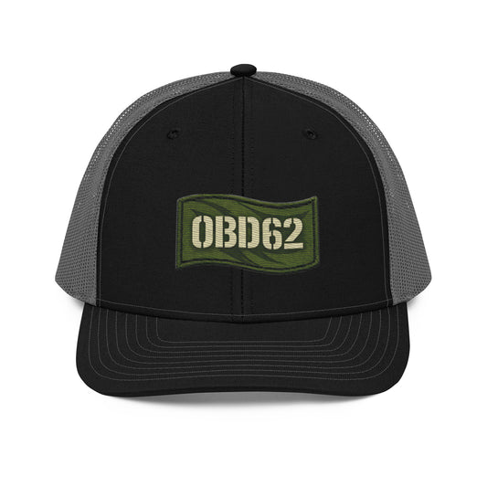 Black OB DANGEROUS OBD62 trucker cap with embroidered logo, snapback style, charcoal front panel, casual streetwear accessory