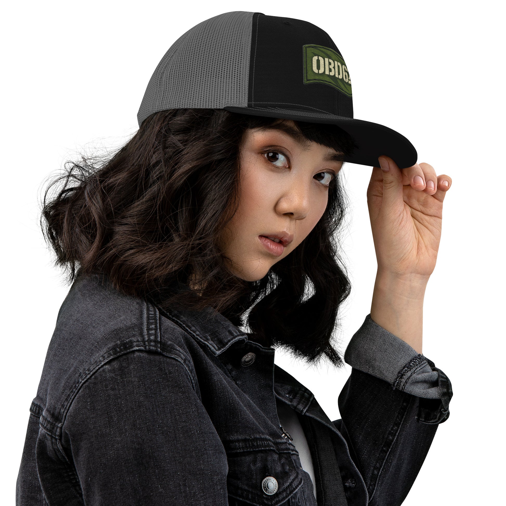 Black embroidered OBD62 Trucker Cap by OB DANGEROUS, featuring a snapback design, viewed from the right side.