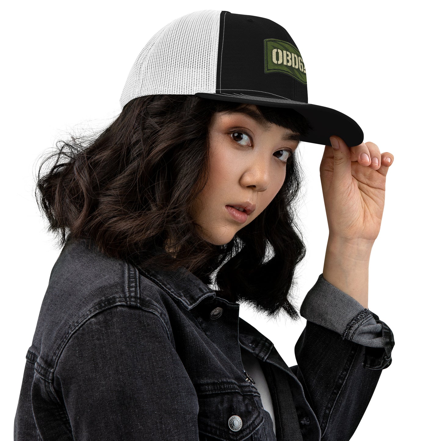 Black and white OB DANGEROY embroidered trucker cap with snapback closure, shown from the right side.