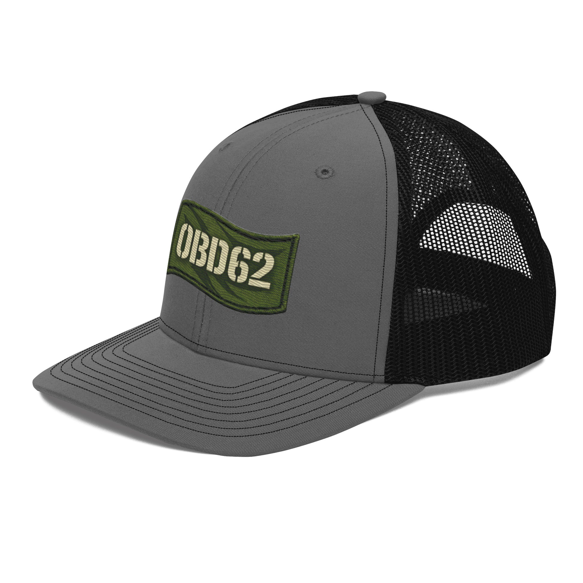 Charcoal black OB DANGEROUS OBD62 trucker cap with embroidered logo, snapback closure, worn on a model's head from the front left view.