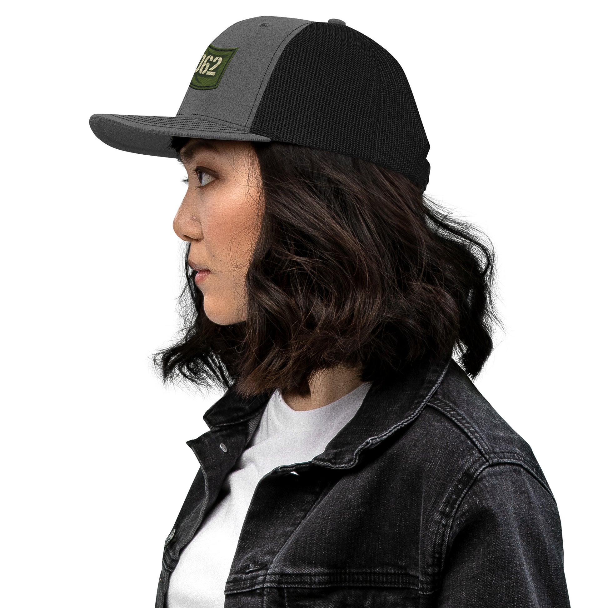 Charcoal black OB DANGEROUS OBD62 trucker cap with embroidered design, viewed from the left side, stylish snapback for gym and streetwear.