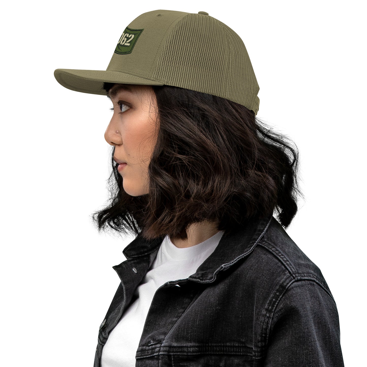 OB DANGEROUS OBD62 embroidered trucker cap in loden green, snapback style, shown from the left side.